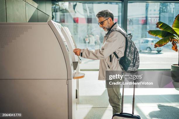 man using a ticket vending machine - train ticket stock pictures, royalty-free photos & images