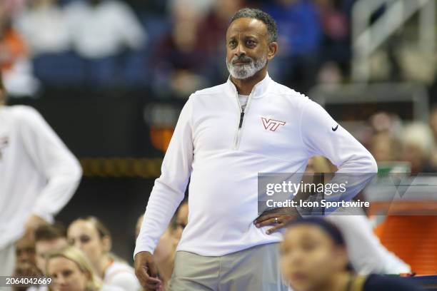 Virginia Tech Hokies head coach Kenny Brooks leans back while watching the three point shot during the college basketball game between the Notre Dame...