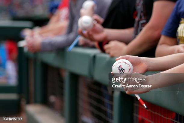 Fan waits for autographs before a spring training game between the Milwaukee Brewers and the Cincinnati Reds at Goodyear Ballpark on March 06, 2024...