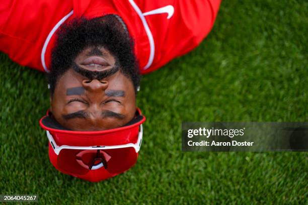 Josh Harrison of the Cincinnati Reds stretches on the field before a spring training game against the Milwaukee Brewers at Goodyear Ballpark on March...