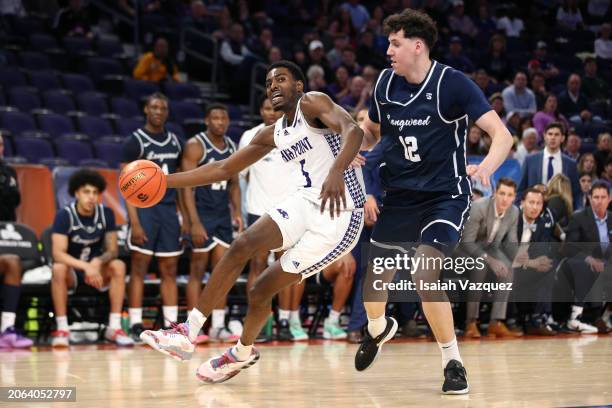 Kimani Hamilton of the High Point Panthers drives to the basket against Szymon Zapala of the Longwood Lancers during the first half of the semifinal...