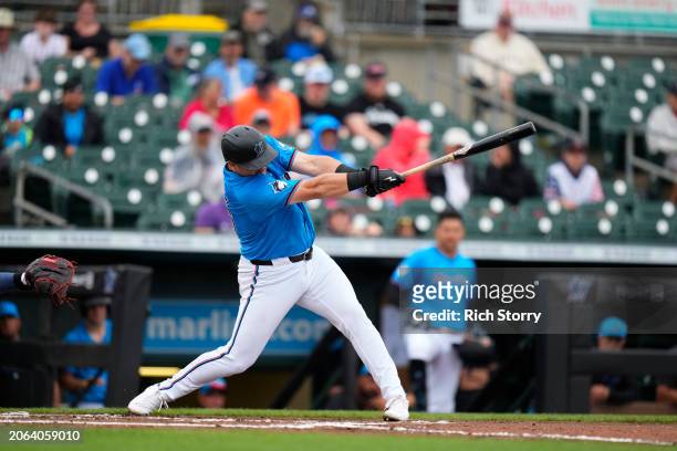 Jake Burger of the Miami Marlins at bat during a spring training game against the Washington Nationals at Roger Dean Stadium on March 06, 2024 in...