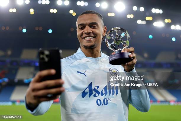 Manuel Akanji of Manchester City poses for a selfie with the PlayStation Player of the Match award at full-time following the team's victory in the...