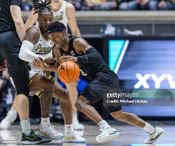 Tyson Walker of the Michigan State Spartans dribbles against Lance Jones of the Purdue Boilermakers at Mackey Arena on March 2, 2024 in West...