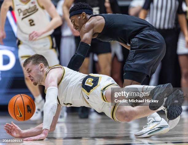 Braden Smith of the Purdue Boilermakers dives for the loose ball against Tyson Walker of the Michigan State Spartans at Mackey Arena on March 2, 2024...