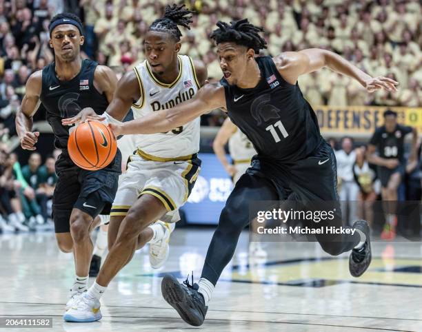 Hoggard of the Michigan State Spartans reaches for the ball against Lance Jones of the Purdue Boilermakers at Mackey Arena on March 2, 2024 in West...