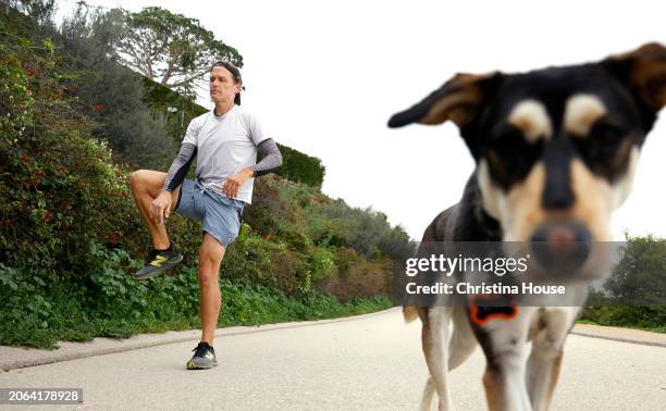 Local resident Brad Hoegl visits Runyon Canyon with his dog, right, on February 29, 2024. The Los Angeles City Council established new parking...