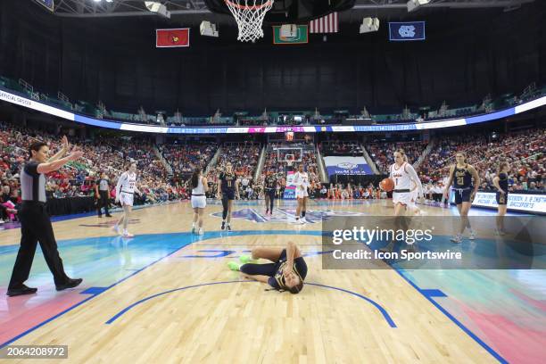 Notre Dame Fighting Irish forward Kylee Watson stays on the floor after an injury during the college basketball game between the Notre Dame Fighting...