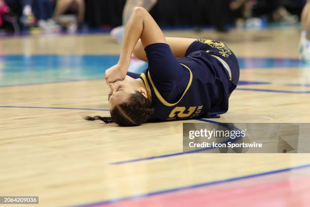 Notre Dame Fighting Irish forward Kylee Watson bites her hand after an injury during the college basketball game between the Notre Dame Fighting...