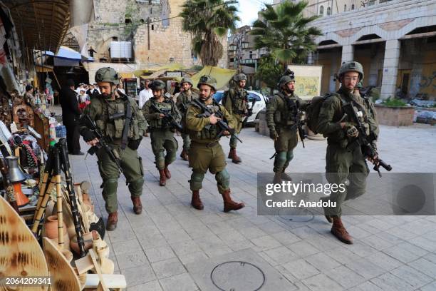 Jewish settlers tour the streets of the Old City under the protection of Israeli soldiers in Hebron, West Bank on March 09, 2024.