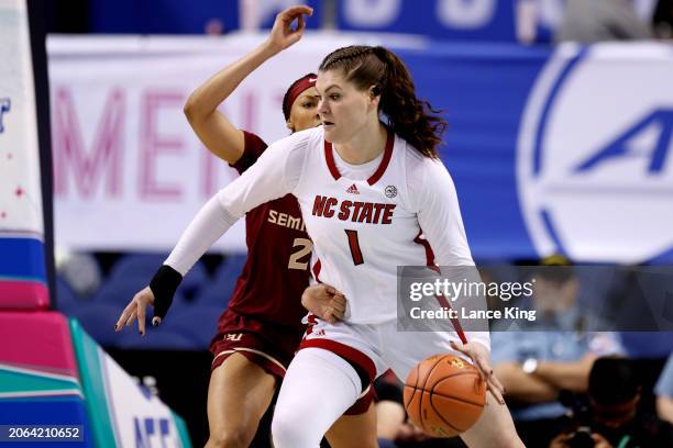 River Baldwin of the NC State Wolfpack moves the ball against Makayla Timpson of the Florida State Seminoles during the first half of the game in the...