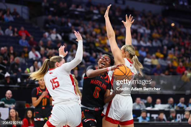 Shyanne Sellers of the Maryland Terrapins attempts a shot while Kendall Moriarty and Natalie Potts of the Nebraska Cornhuskers defend in the...