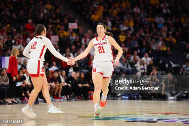 Maddie Krull and Annika Stewart of the Nebraska Cornhuskers celebrate a three point basket against the Maryland Terrapins in the Semifinal Round of...