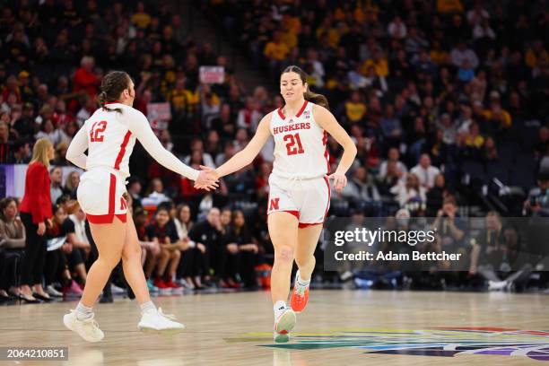 Maddie Krull and Annika Stewart of the Nebraska Cornhuskers celebrate a three point basket against the Maryland Terrapins in the Semifinal Round of...