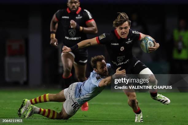 Toulouse's French centre Paul Costes is tackled during the French Top14 rugby union match between USA Perpignan and Stade Toulousain Rugby at the...