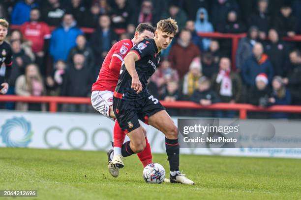 Joe Adams is tackling Wrexham's Max Cleworth during the Sky Bet League 2 match between Morecambe and Wrexham at the Globe Arena in Morecambe, on...