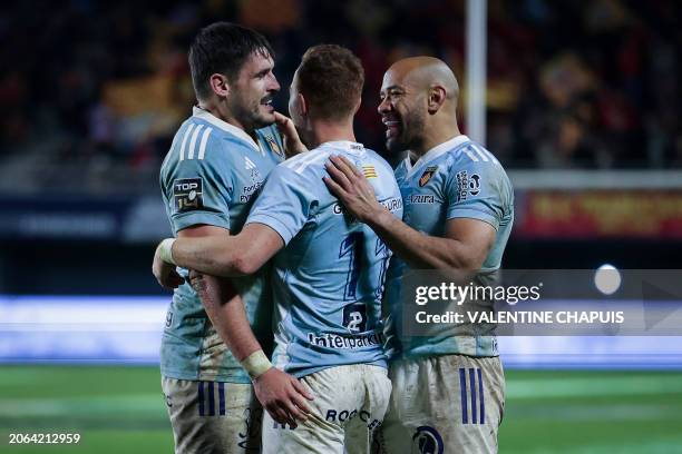 Perpignan's French wing Lucas Dubois celebrates after scoring a try with Perpignan's French flanker Alan Brazo and Perpignan's Australian centre...