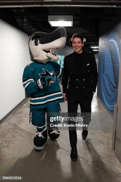 Devin Cooley of the San Jose Sharks arrives at the arena and is greeted by S.J. Sharkie before the game against the Ottawa Senators at SAP Center on...
