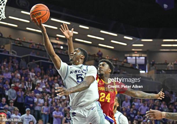 Cam Carter of the Kansas State Wildcats drives to the basket with the ball against Hason Ward of the Iowa State Cyclones in the second half at...