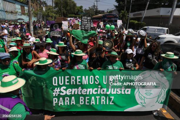 Demonstrators march carrying Pro-Choice posters, banners and green scarves during a demonstration a day after International Women's Day on March 9,...