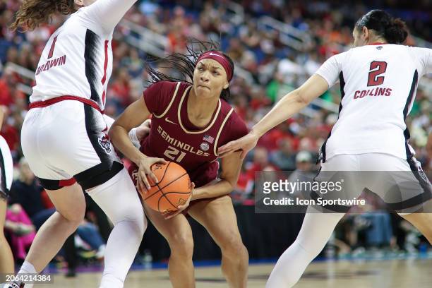 Florida State Seminoles forward Makayla Timpson looks to the basket as NC State Wolfpack center River Baldwin defends during the college basketball...