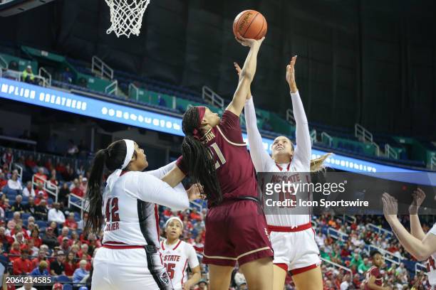 Florida State Seminoles forward Makayla Timpson and NC State Wolfpack center Lizzy Williamson go ups or the rebound during the college basketball...