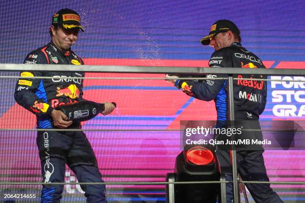Sergio Perez of Mexico and Oracle Red Bull Racing and Max Verstappen of the Netherlands and Oracle Red Bull Racing celebrate on the podium during the...