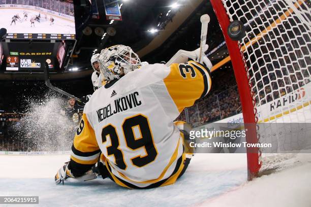 Alex Nedeljkovic of the Pittsburgh Penguins looks back to see a shot by Pavel Zacha of the Boston Bruins go in for a goal during the thrid period at...