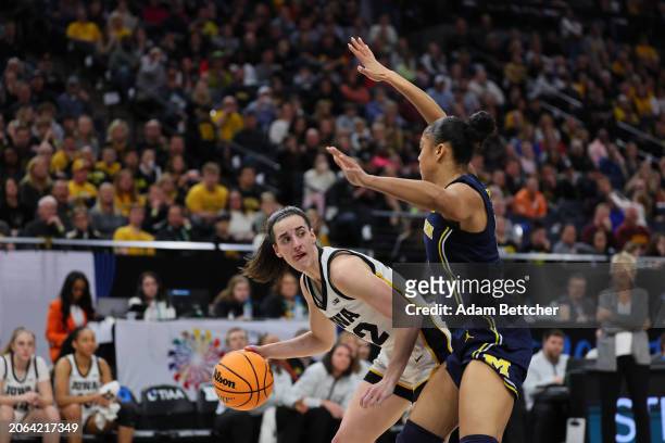 Caitlin Clark of the Iowa Hawkeyes tries to get around the defense of Laila Phelia of the Michigan Wolverines in the Semifinal Round of the Big Ten...