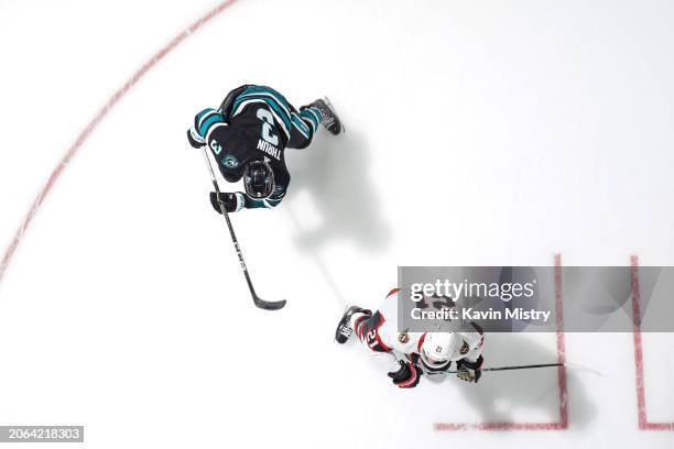 An overhead view as Henry Thrun of the San Jose Sharks skates after the puck in the first period against Mathieu Joseph of the Ottawa Senators at SAP...