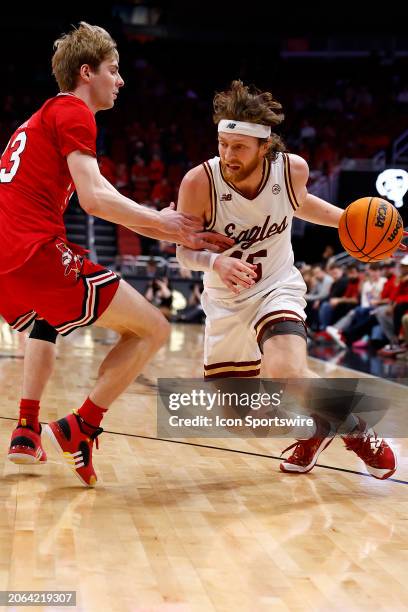 Boston College Eagles guard Mason Madsen battles to get around dLouisville Cardinals guard Aidan McCool during a mens college basketball game between...