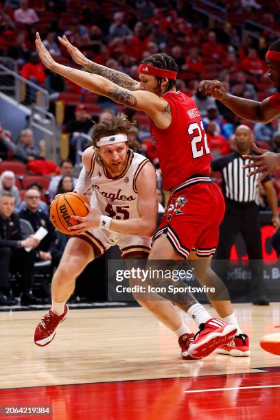 Boston College Eagles guard Mason Madsen drives into Louisville Cardinals guard Tre White in the second half of play during a mens college basketball...