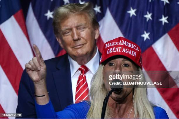 Representative Marjorie Taylor Greene speaks alongside former US President and 2024 presidential hopeful Donald Trump at a campaign event in Rome,...