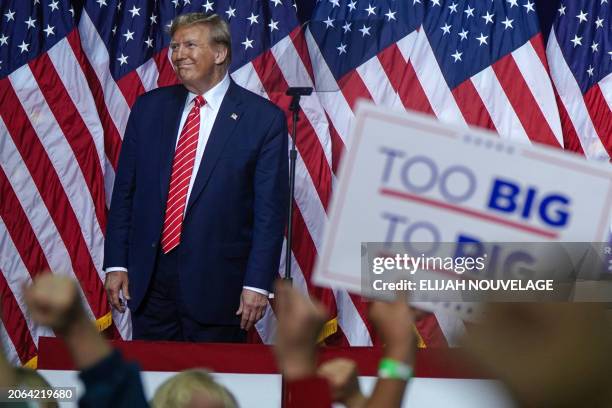 Former US President and 2024 presidential hopeful Donald Trump gestures to the crowd after speaking at a campaign event in Rome, Georgia, on March 9,...