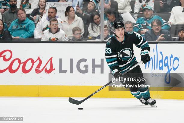 Calen Addison of the San Jose Sharks skates with the puck in the second period against the Ottawa Senators at SAP Center on March 9, 2024 in San...