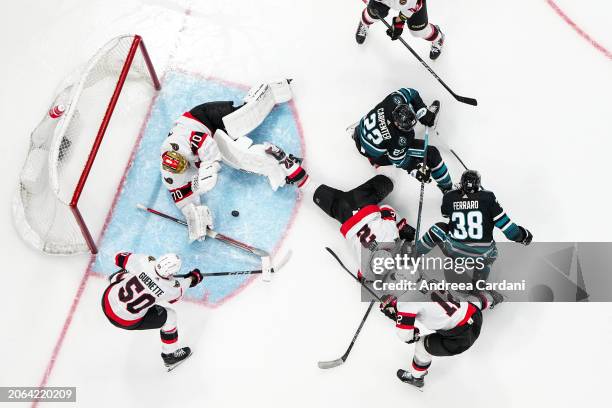 An overhead shot of Joonas Korpisalo of the Ottawa Senators stopping the puck in the second period against the San Jose Sharks at SAP Center on March...