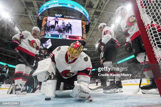 Joonas Korpisalo of the Ottawa Senators dives on the puck to make a save against the San Jose Sharks in the second period at SAP Center on March 9,...