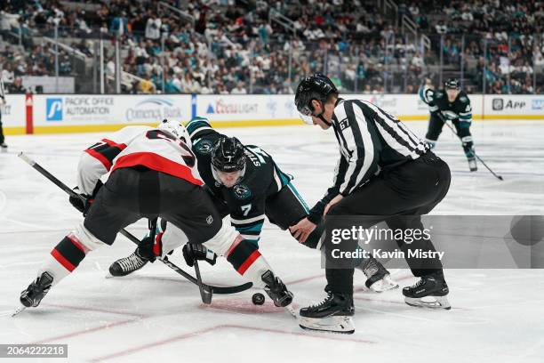 Nico Sturm of the San Jose Sharks takes a face-off against Shane Pinto of the Ottawa Senators in the third period at SAP Center on March 9, 2024 in...