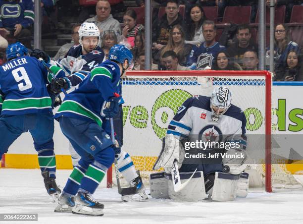 Miller of the Vancouver Canucks scores a goal on Connor Hellebuyck of the Winnipeg Jets during the first period of their NHL game at Rogers Arena on...