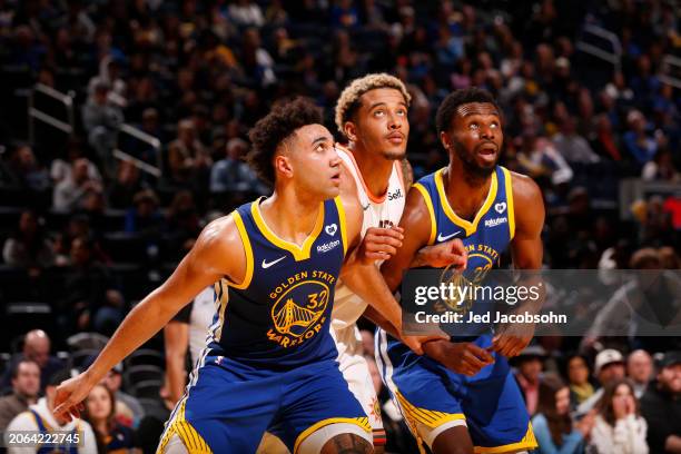 Trayce Jackson-Davis, Andrew Wiggins of the Golden State Warriors and Jeremy Sochan of the San Antonio Spurs looks on during the game on March 9,...