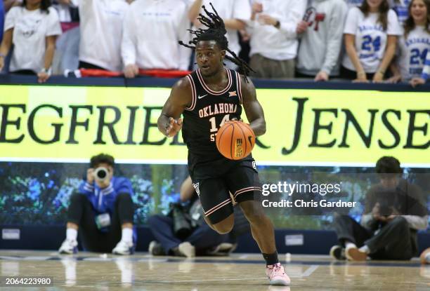 Jamyron Keller of the Oklahoma State Cowboys rushes the ball up the court during the first half of their game against the Brigham Young Cougars at...