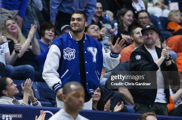 Star and former player of the Brigham Young Cougars Puka Nacua waves as he receives an ovation during the second half of the game between the Cougars...