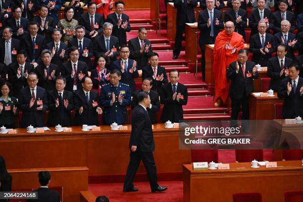 China's President Xi Jinping is applauded as he arrives for the closing session of the Chinese People's Political Consultative Conference at the...