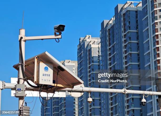 Public security authorities are setting up surveillance equipment on a street in Yantai, East China's Shandong province, on March 9, 2024. On...