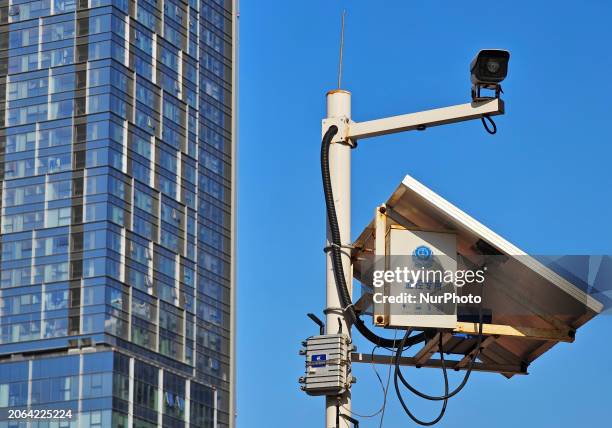 Public security authorities are setting up surveillance equipment on a street in Yantai, East China's Shandong province, on March 9, 2024. On...