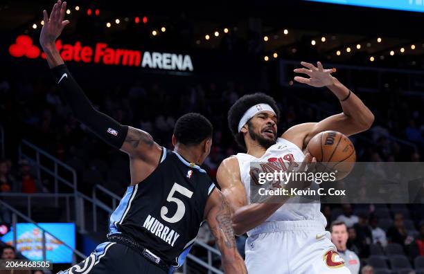 Dejounte Murray of the Atlanta Hawks defends against Jarrett Allen of the Cleveland Cavaliers during the first quarter at State Farm Arena on March...