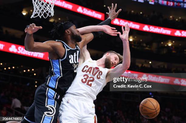 Bruno Fernando of the Atlanta Hawks blocks a shot by Dean Wade of the Cleveland Cavaliers during the second quarter at State Farm Arena on March 06,...