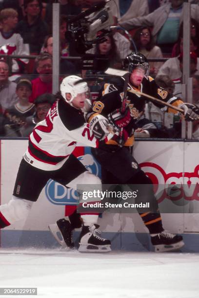 Pittsburgh Penguins forward, Jaromir Jagr, tries to escape the clutch from Devil's forward, Claude Lemieux, during the game against the NJ Devils at...