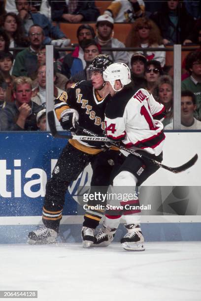 Pittsburgh Penguins forward, Jaromir Jagr, getting tied up along the boards by Devil's forward Kevin Todd during the game against the NJ Devils at...