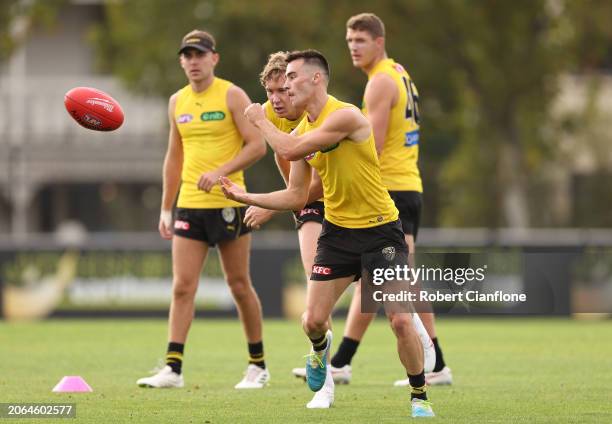 Seth Campbell of the Tigers handballs during a Richmond Tigers AFL Training Session & Media Opportunity at Punt Road Oval on March 07, 2024 in...